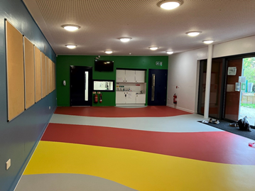 Empty room with whiteboards and coloured flooring
